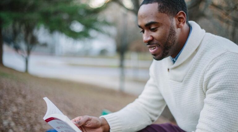 man reading about how to write an interesting story