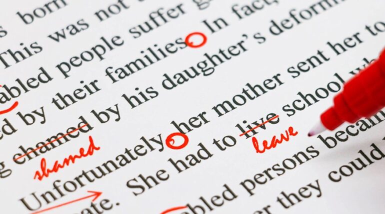 red marker on paper with red markings showing proofreading