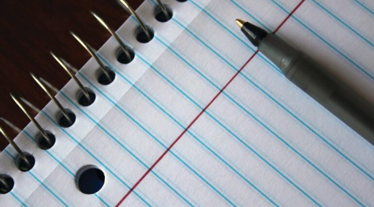 empty page of book with pen on top for a writer who wants to write in a more relatable fashion