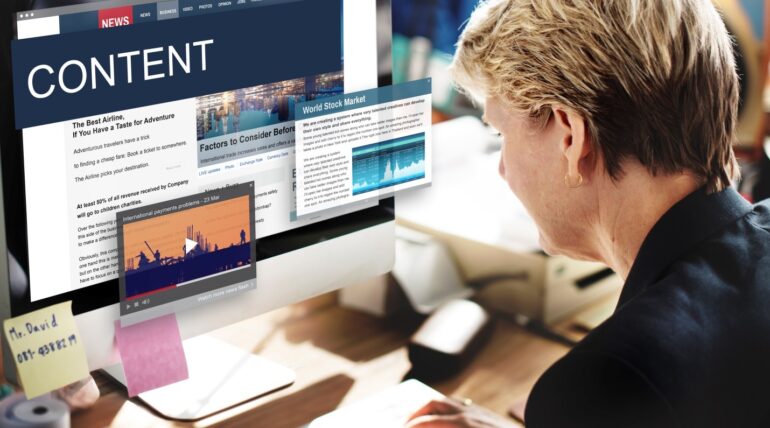 woman writing better content on desktop computer